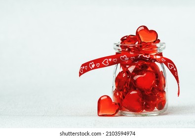 Two Red Glass Hearts And A Jar Full Of Hearts