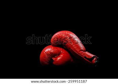 Two red gloves on a black background