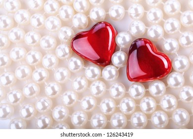 two red hearts with beads of pearls - Powered by Shutterstock