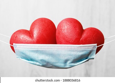 Two Red Hearts In A Face Mask Hammock. Stay Safe At Home For Holidays. Happy Valentines Day During Pandemic. Thank You Frontline Workers.