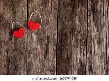 Two Red Hearts On A Rustic Wood Background