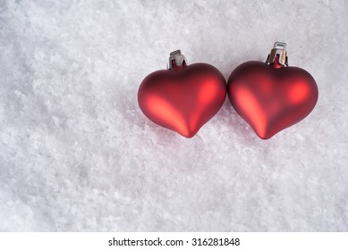 Two Red Hearts On Snow, Christmas Decoration, Background For Giftcard