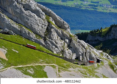 The two red Pilatus train, the world's steepest cogwheel railway nears the top of Mount Pilatus.