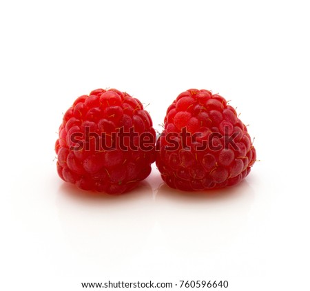 Two red raspberries isolated on white background
