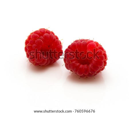 Two red raspberries isolated on white background

