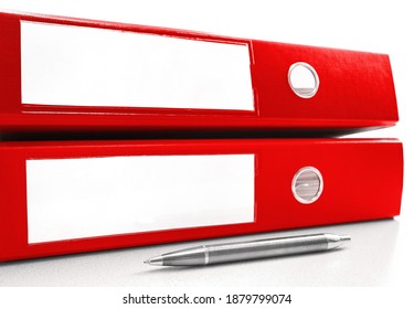 Two Red Ring Binder On A Table