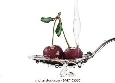 Two Red Sweet Cherry Berries In A Tablespoon With Drops Of Water In A White Background In Horizontal Format