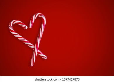 Two red and white candy canes in the shape of heart on a red background. Valentine's Day concept. Greeting card with copy space for your text or advertising, flat lay - Powered by Shutterstock