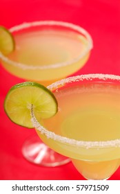 Two Refreshing Margaritas With Slices Of Lime On Salt Rimmed Glasses