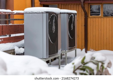 Two Residential Modern Heat Pumps Buried In Snow