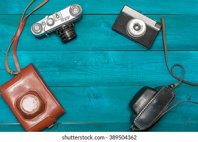 Two retro camera lying on the aged boards, flat lay
