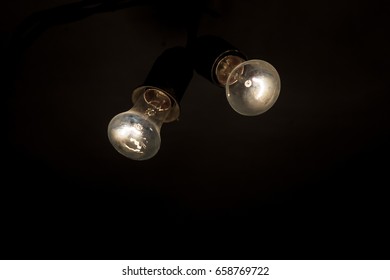 Two retro light bulb in the dark . New ideas
