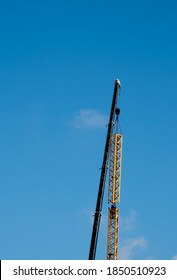 Two Riggers Mounting Tower Crane At Construction Site. Industrial Background. Perfect Match Concept. 