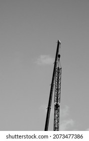 Two Riggers Mounting Tower Crane At Construction Site. Industrial Background. Perfect Match Concept. Black White Historic Photo. Selective Focus.