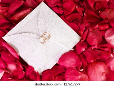 two rings on the wedding card among the rose petals - Powered by Shutterstock