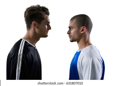 Two Rival Football Player Looking At Each Other Against White Background