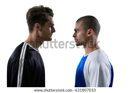 Two rival football player looking at each other against white background