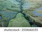 Two river gullies join to form one heading downhill on the Black mountain in South Wales UK
