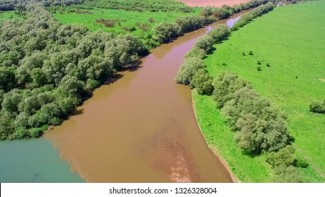 Two Rivers Of Different Colors Of Water Merge Into One Large Riv