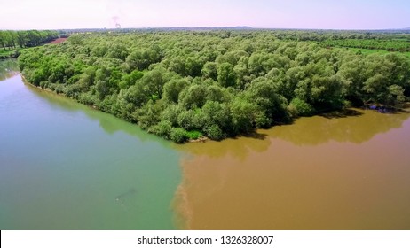 Two Rivers Of Different Colors Of Water Merge Into One Large Riv