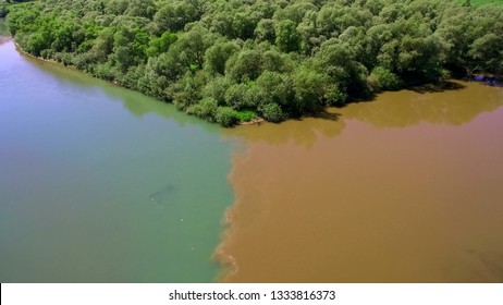 Two Rivers Of Different Colors Of Water Merge Into One Large Riv