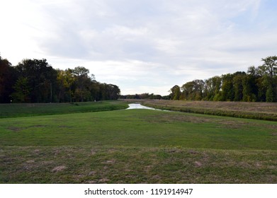 Two Rivers That Merge, With Meadow And Trees