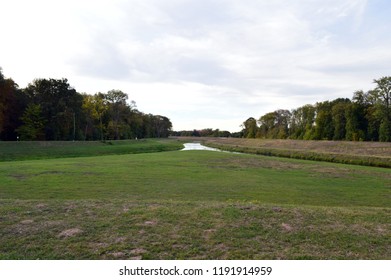 Two Rivers That Merge, With Meadow And Trees