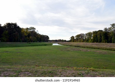 Two Rivers That Merge, With Meadow And Trees