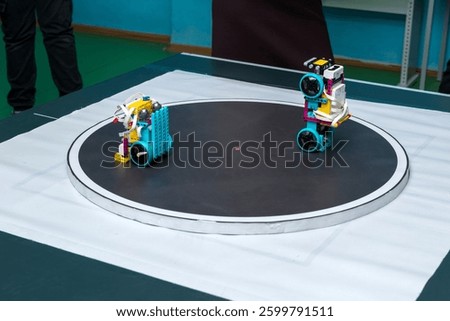 Two robots in a black ring in a 10x10 sumo competition