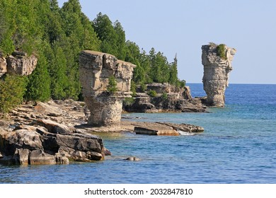 The two rock pillars rise from the waters of Georgian Bay on Flowerpot island in Fathom Five National Marine Park, Lake Huron, Canada - Shutterstock ID 2032847810