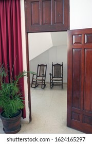 Two Rocking Chairs In A Church.