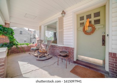 Two Rocking Chairs On A Covered Front Porch