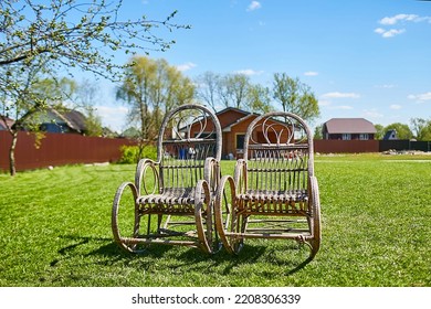 Two Rocking Chairs On Green Grass In Summer