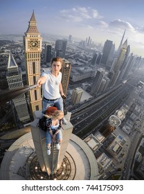 Two roofers do selfie on tall skyscraper in Dubai, United Arab Emirates