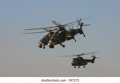 Two Rooivalk And Oryx Helicopter In Hover Above Airport