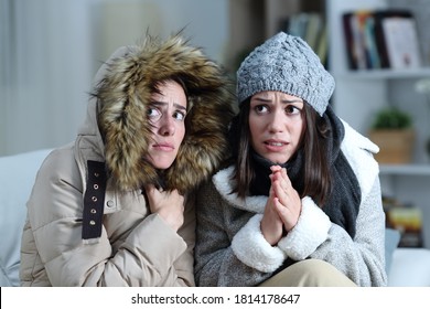 Two Roommates Shivering In A Cold Winter Day On A Couch In The Living Room At Home 