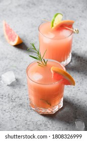 Two Rosemary Grapefruit Sodas On Light Grey. Vertical Format. Mocktail Paloma. Close Up. Greyhound Drink.