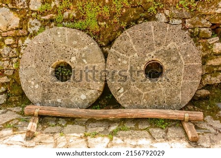 two round stones used in a mill to make gunpowder