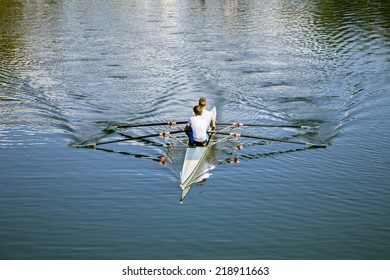 Two Rowers In A Boat, Rowing On The Tranquil Lake 