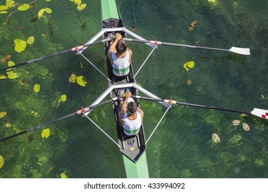 Two Rowers In A Boat, Rowing On The Tranquil Lake 