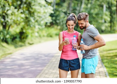 Two Runners Checking Achievements On Mobile Phone App