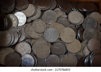 Two rupees nickel coins of India. Heap of coins photographed. Large pile of money coins. Some of them are Corroded. Written in Hindi language Bharat and two rupaye coins. Devnagari. 