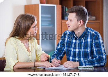 two russian collegues working with documents together in office