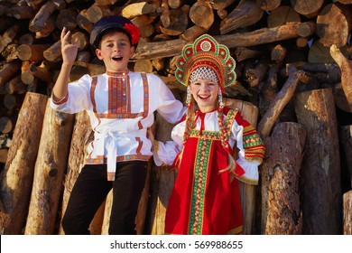 Two Russian Kids In Russian Folk Costume Boy And Girl Dancing Together And Emotionally Smiling