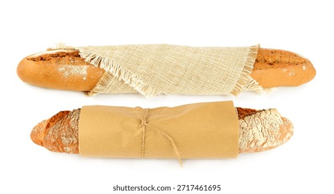 Two rustic baguettes, one wrapped in brown paper and twine, the other in burlap, are presented horizontally on a white background. This image conveys fresh baking, traditional food, and quality with clean copy space.