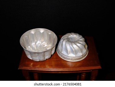 Two Rustic Jello Moulds Or Molds On Wood Table With Black Background Used For Jelly Or Jello Salads