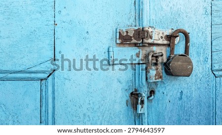 Two rusty padlocks securing a wooden door, symbolizing security, protection, privacy, restriction, and the passage of time. Weathered metal and aged wood create a strong vintage and historical atmosphere. Suitable for security, abandonment, heritage architecture, mystery, and access control concepts.