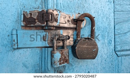 Two rusty padlocks securing a wooden door, symbolizing security, protection, privacy, restriction, and the passage of time. Weathered metal and aged wood create a strong vintage and historical atmosphere. Suitable for security, abandonment, heritage architecture, mystery, and access control concepts.