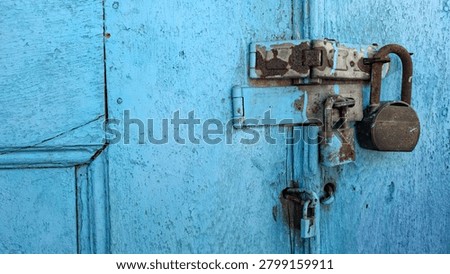 Two rusty padlocks securing a wooden door, symbolizing security, protection, privacy, restriction, and the passage of time. Weathered metal and aged wood create a strong vintage and historical atmosphere. Suitable for security, abandonment, heritage architecture, mystery, and access control concepts.