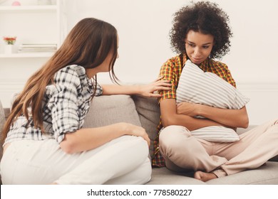 Two Sad Diverse Women Talking At Home. Female Friends Supporting Each Other. Problems, Friendship And Care Concept